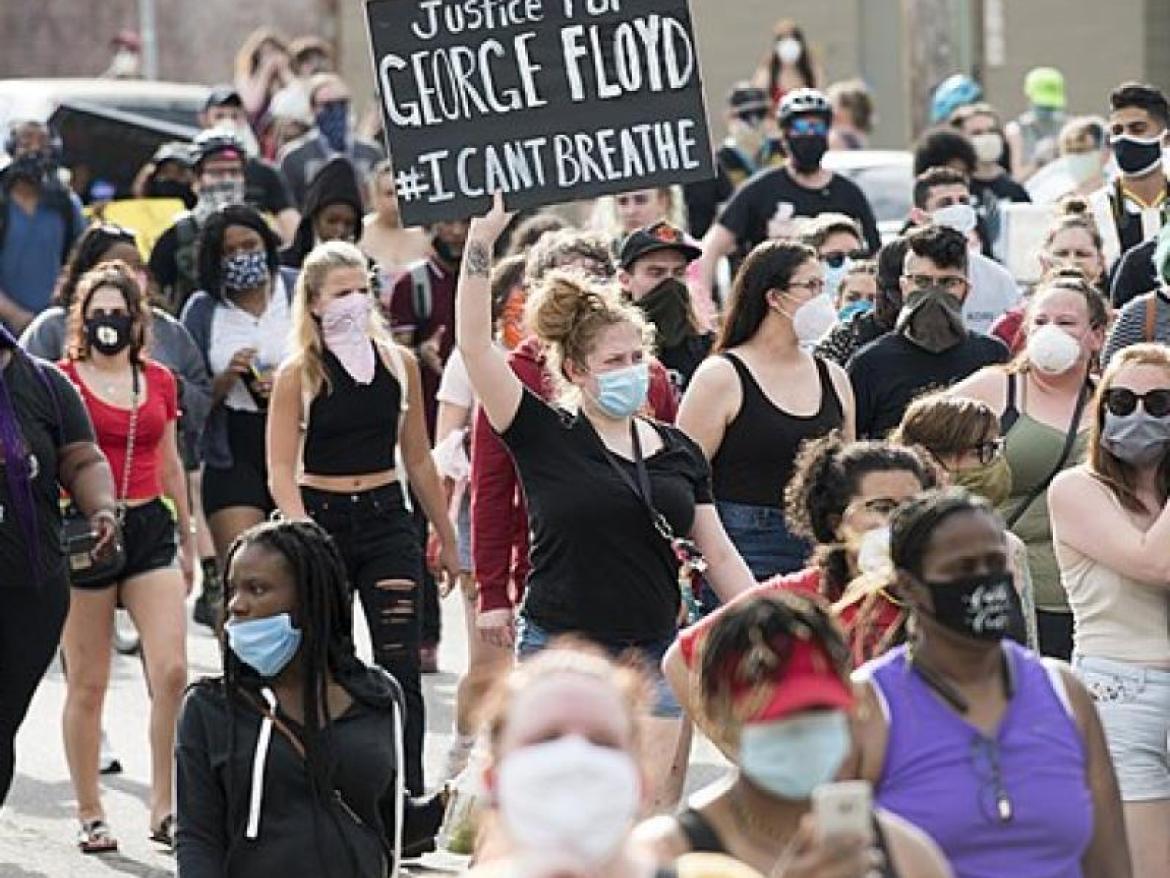 Protest with a sign reading 'Justice for George Floyd'