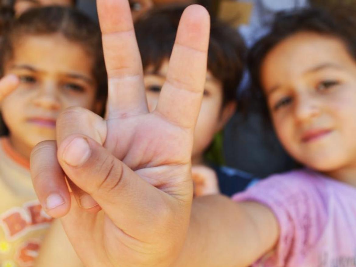 Syrian Refugee kids showing a peace sign