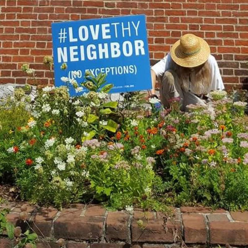 Love thy Neighbor sign in garden